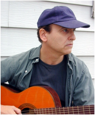A serious Evan Paul playing his guitar